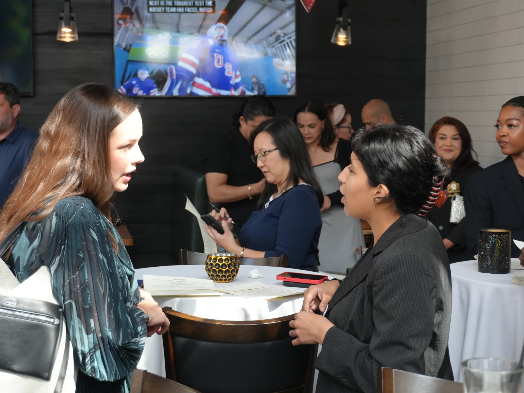 Small Talk guests sharing conversation around a table at Osso & Kristalla